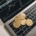 Bitcoin coins on a laptop keyboard with a crypto market chart, symbolizing the need for the Voluntary Disclosure Programme for crypto traders.