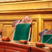 Ornate green parliamentary chairs with microphones symbolizing tax policy debate in South Africa’s parliament