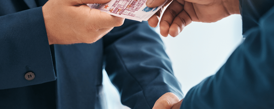 Businessmen discussing SARB tax compliance transfer while exchanging money